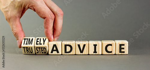 Timely or trusted advice symbol. Concept words Timely advice and Trusted advice on wooden cubes. Businessman hand. Beautiful grey background. Business timely or trusted advice concept. Copy space.