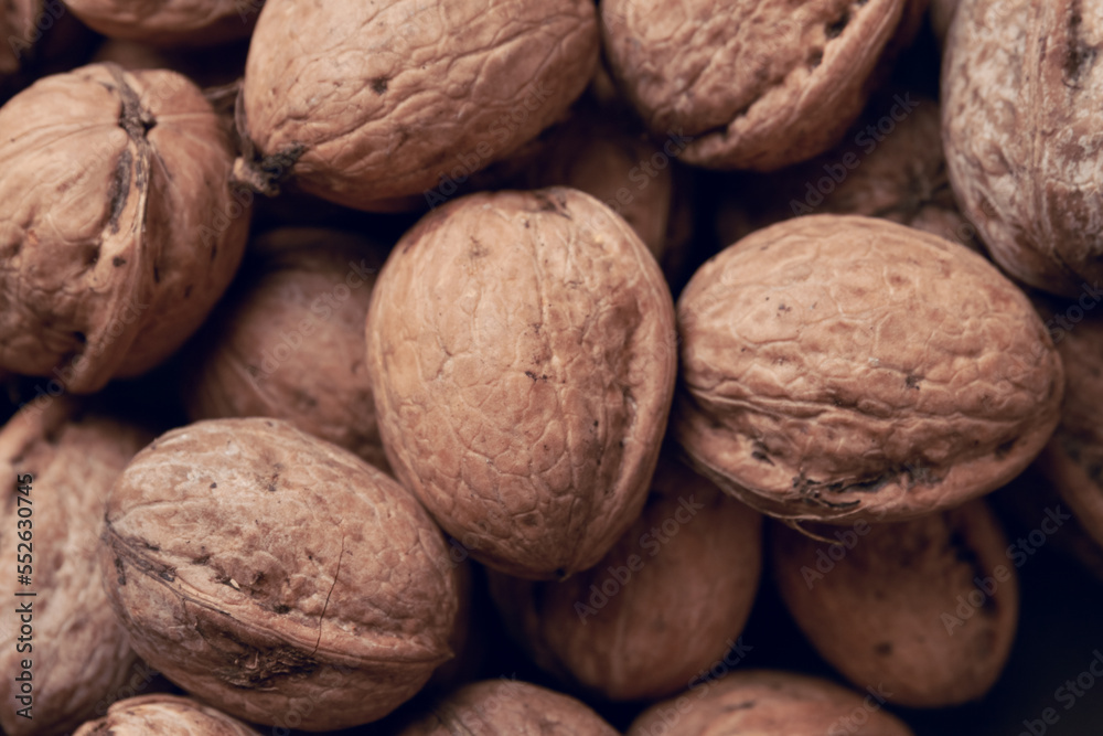 Walnuts with and without shells as background. Walnuts with and without shells as background.