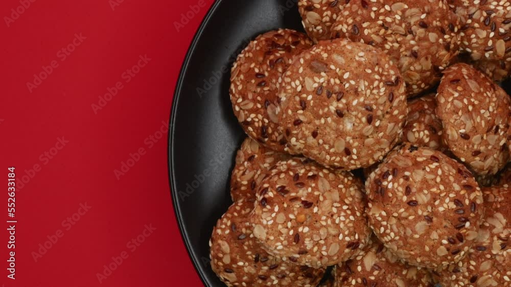 Freshly Baked Cookies Rotating On A Black Plate On A Red Background On The Right Side. Top View. 4k, ProRes Freshly Baked Cookies Rotating On A Black Plate On A Red Background On The Right Side. Top View. 4k, ProRes