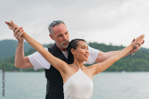 luxury relaxing couple traveler of cruise yacht with background of sea and white sky. Concept business travel. Cruise luxury travel lifestyle businessman and woman on vacation.