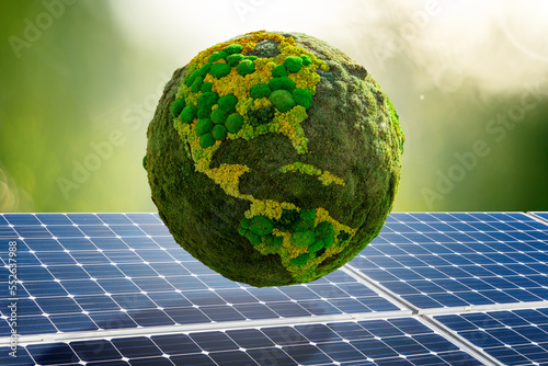 Fototapeta Naklejka Na Ścianę i Meble -  Green planet Earth from natural moss on a background of solar panels. Symbol of sustainable development and renewable energy