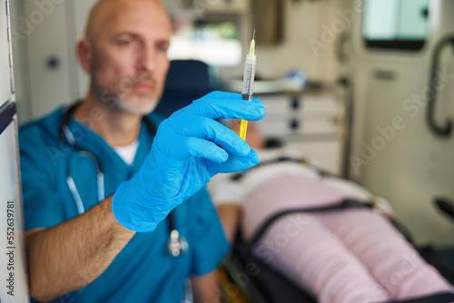 Doctor in medical gloves is preparing to apply an injection