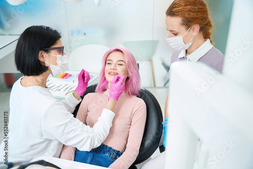 Young pink-haired woman at an orthodontist appointment