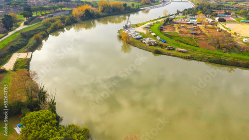 Aerial view over the Tiber River near Ostia in Rome, Italy. Autumn colors dye the trees along the river.
