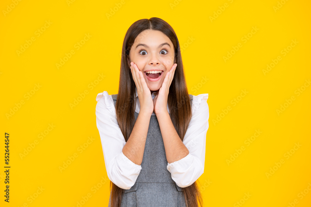 Excited face. Amazed expression, cheerful and glad. Emotional portrait of caucasian teenager child girl isolated on studio yellow background. Excited face. Amazed expression, cheerful and glad. Emotional portrait of caucasian teenager child girl isolated on studio yellow background.