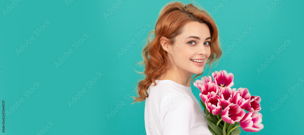 happy girl with tulip flower bouquet on blue background. womens day. Woman isolated face portrait, banner with mock up copyspace. happy girl with tulip flower bouquet on blue background. womens day. Woman isolated face portrait, banner with mock up copyspace.
