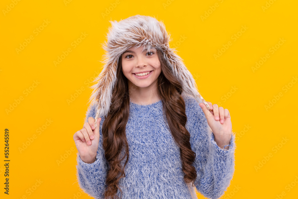 winter fashion. glad kid with curly hair in earflap hat. female fashion model.