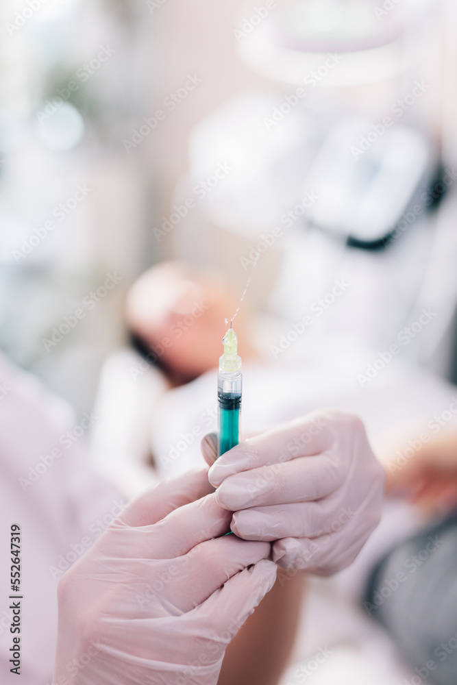 Aesthetic medicine doctor preparing syringe for injection Aesthetic medicine doctor preparing syringe for injection