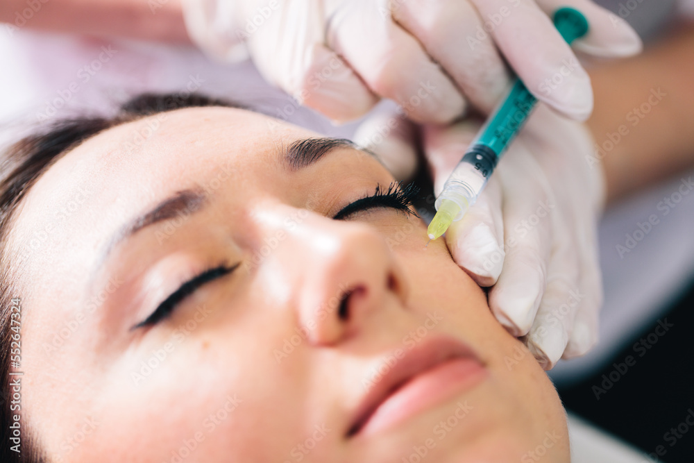Injectable tissue stimulator on woman face in beauty salon