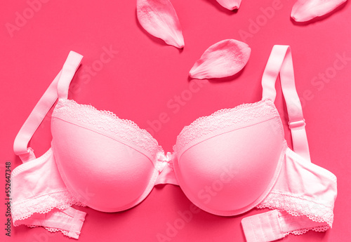 White new bra on a magenta background. Bra, lace lingerie on a viva magenta background. Beauty blog concept. Top view, flat lay. color of the 2023 year 