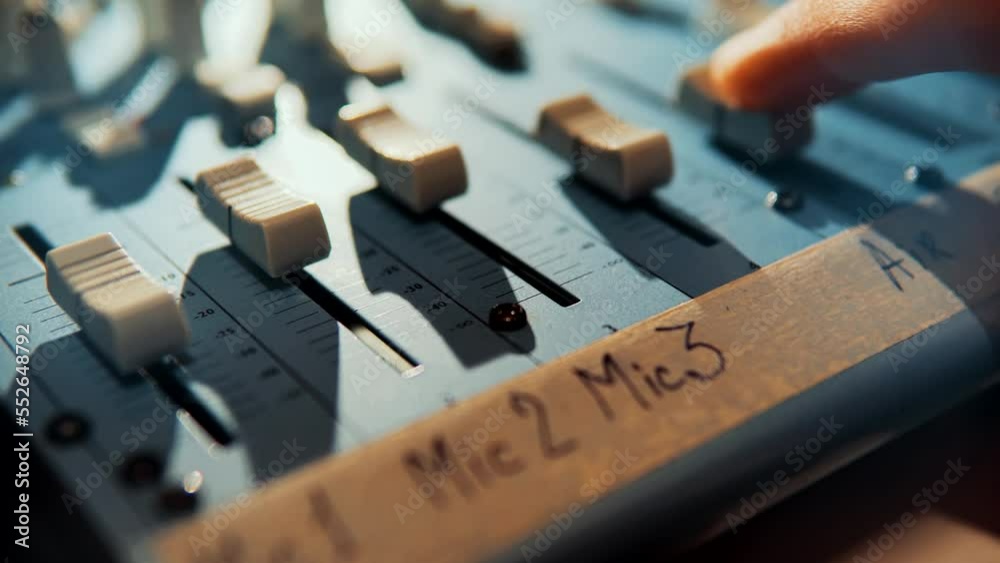 radio station broadcast engineer press key . composer on audio mixer