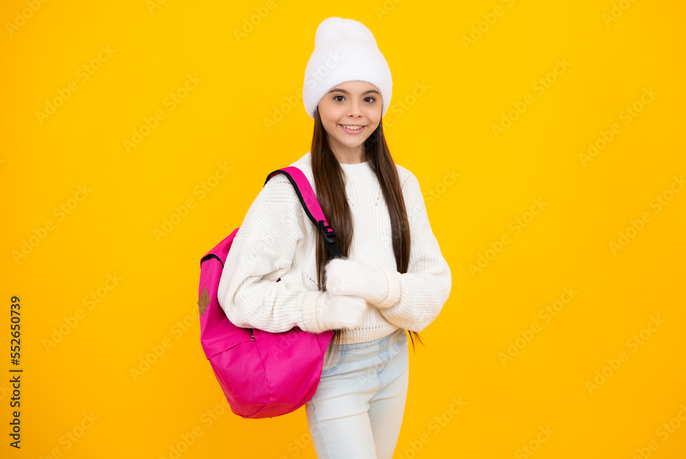 Autumn school holiday. Back to school. Teenager schoolgirl in autumn clothes on yellow isolated studio background. Autumn school holiday. Back to school. Teenager schoolgirl in autumn clothes on yellow isolated studio background.