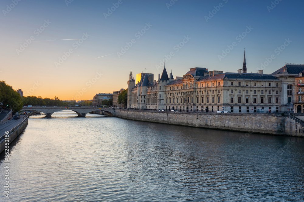 The Conciergerie palace and prison by the Seine river at dawn, Paris. France