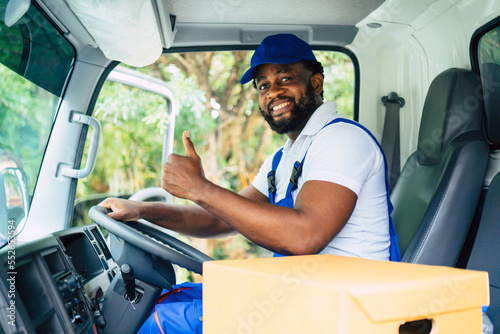 African American man smiling toward camera raise thumb up, confident delivery, moving house, shipping, courier man, professional service, sitting driving in truck.