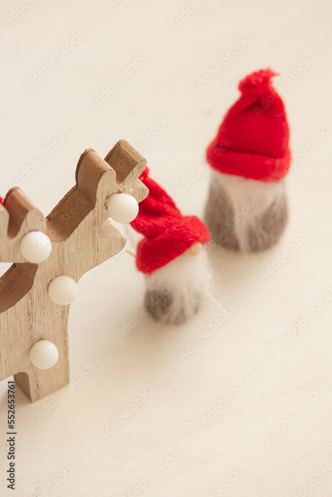 custom made wallpaper toronto digitalScandinavian winter décor. Wooden deer and cute gnomes in red knitted hats on white background, top view