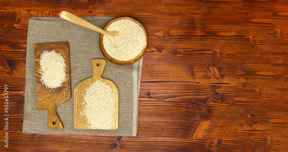Sesame seed Sesamum indicum, wooden background. The concept of healthy food and drinks. Copy space