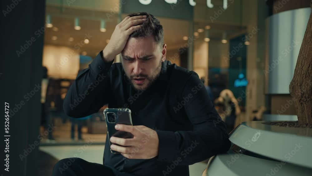 Upset anxious businessman 30s man having problem with mobile telephone read bad news unpleasant email on phone software error receive denial answer fail business deal disappointed male make mistake Upset anxious businessman 30s man having problem with mobile telephone read bad news unpleasant email on phone software error receive denial answer fail business deal disappointed male make mistake