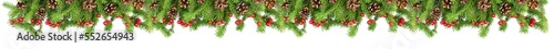 Fir branches with golden bows, red berries and pine cones isolated on a white background.