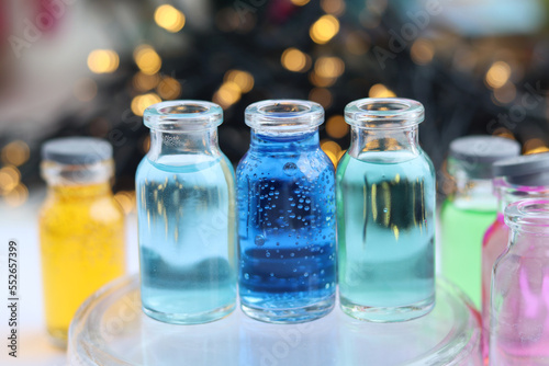 Solutions of blue and green indicator dyes are in three glass jars.