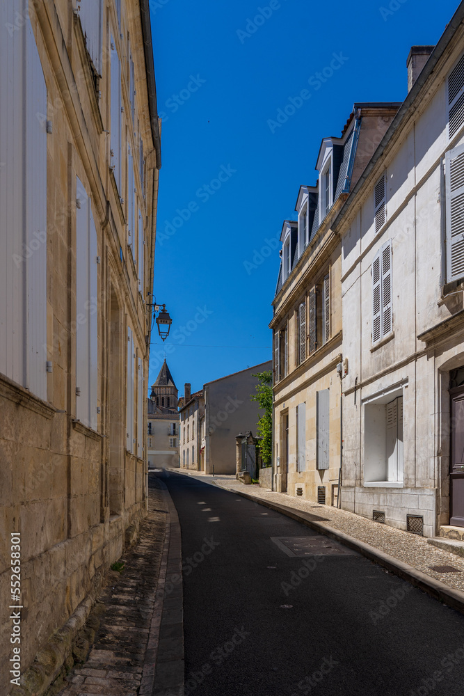 A narrow street in a French small town with a home.