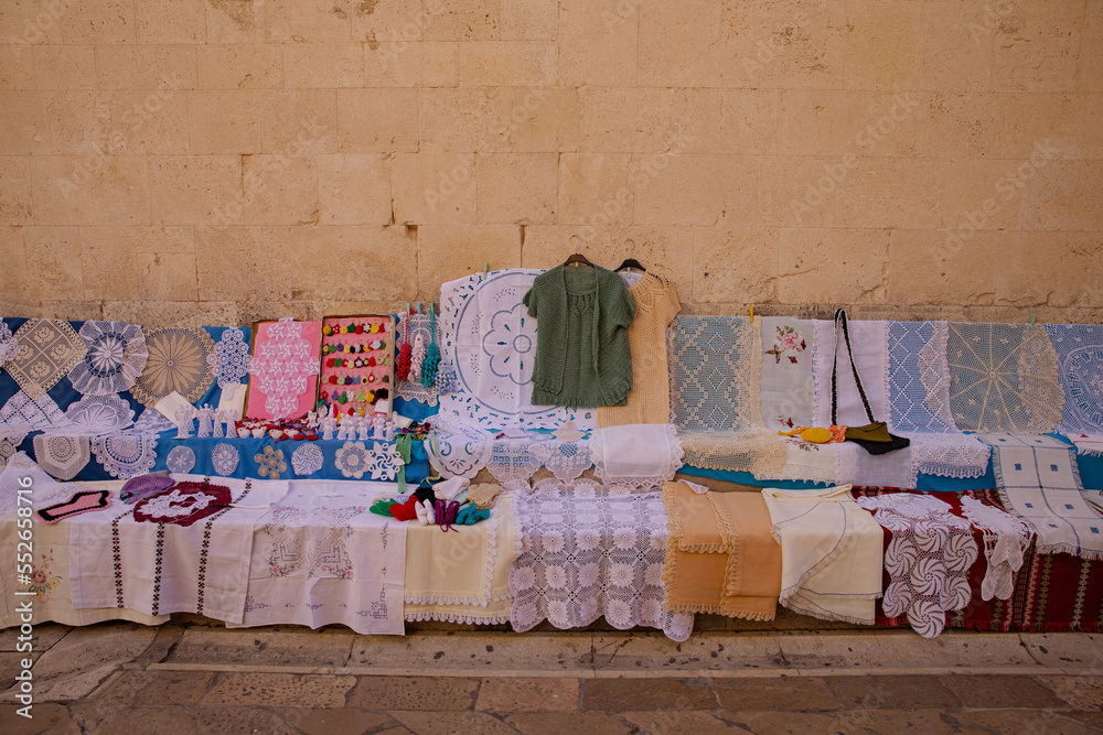 Lace for sale. Lace is sold on the streets of the old town. Lace patterns for every taste. Needlework as a gift. Handwork - a great value