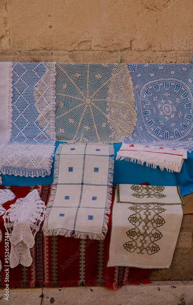 Lace for sale. Lace is sold on the streets of the old town. Lace patterns for every taste. Needlework as a gift. Handwork - a great value