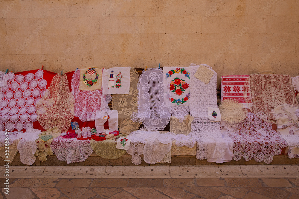 Lace for sale. Lace is sold on the streets of the old town. Lace patterns for every taste. Needlework as a gift. Handwork - a great value