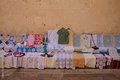 Obraz na płótnie Lace for sale. Lace is sold on the streets of the old town. Lace patterns for every taste. Needlework as a gift. Handwork - a great value w salonie