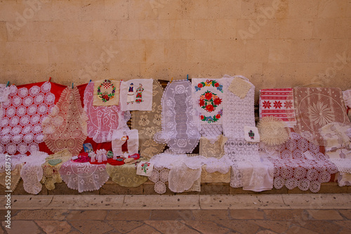 Obraz na płótnie Lace for sale. Lace is sold on the streets of the old town. Lace patterns for every taste. Needlework as a gift. Handwork - a great value w salonie