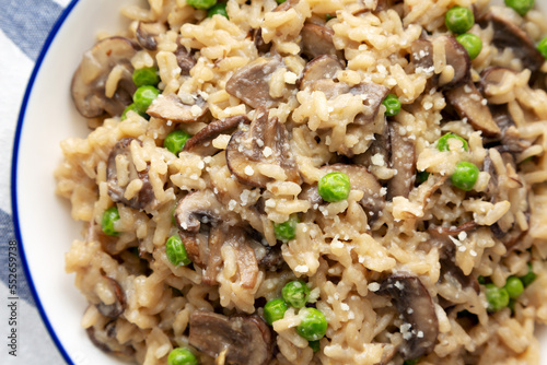 Homemade Mushroom Risotto with Peas on a Plate, top view. Flat lay, overhead, from above. Close-up.