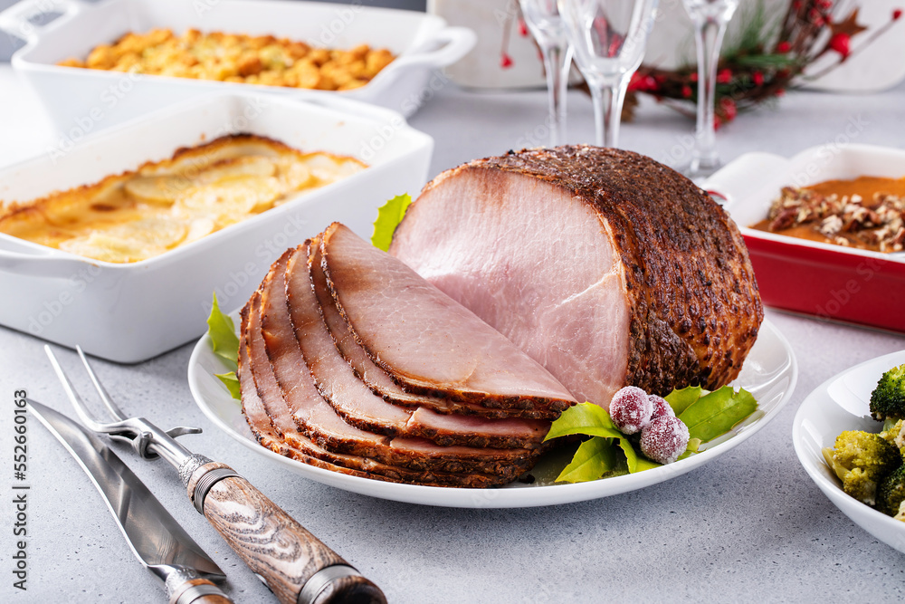 Christmas dinner with honey spiral sliced ham and side dishes Stock