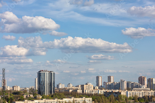 Blue sky with white cloudsin in a autumn cityscape.
