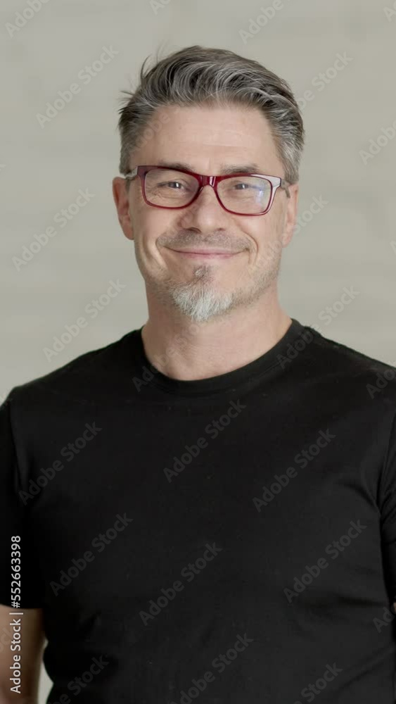 Happy confident older man is his 50s looking at the camera through glasses, smiling. 4K UHD video clip. Happy confident older man is his 50s looking at the camera through glasses, smiling. 4K UHD video clip.