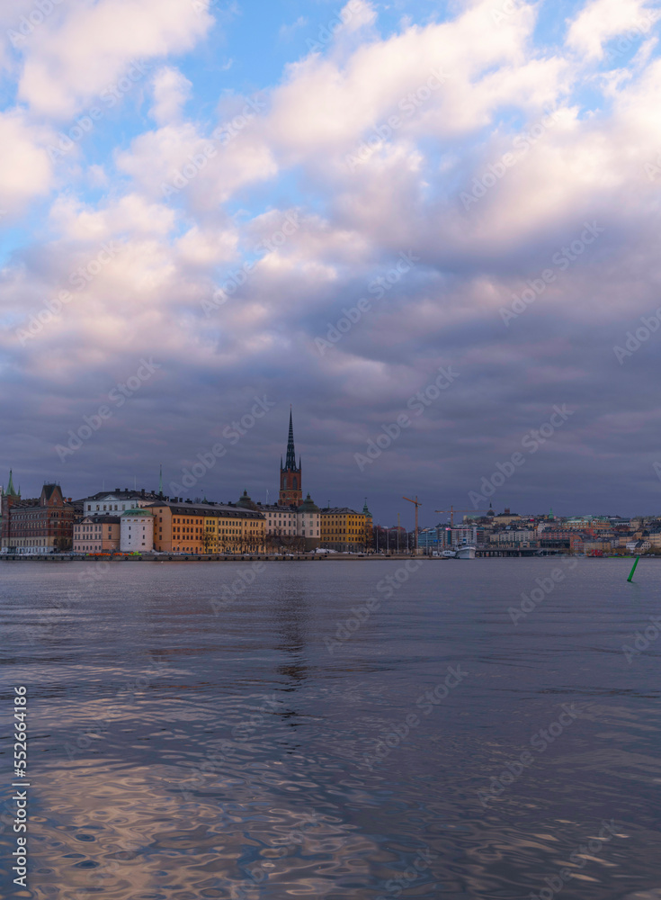 The island Riddarholmen at the bay Riddarfjärden, snow clouds cover the skyline a winter day in Stockholm