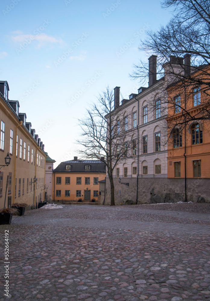 Alley with old 1800s court houses a winter day with low sun in Stockholm