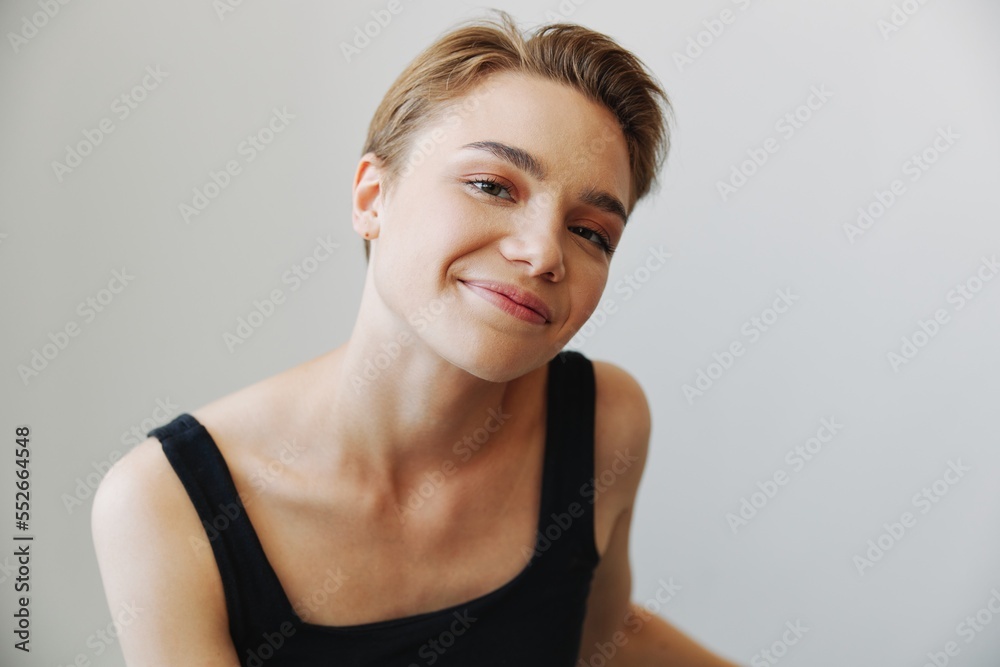 Young woman with short haircut hair having fun at home on the couch smile and happiness, vacation at home, natural posing without filters, free copy space Young woman with short haircut hair having fun at home on the couch smile and happiness, vacation at home, natural posing without filters, free copy space