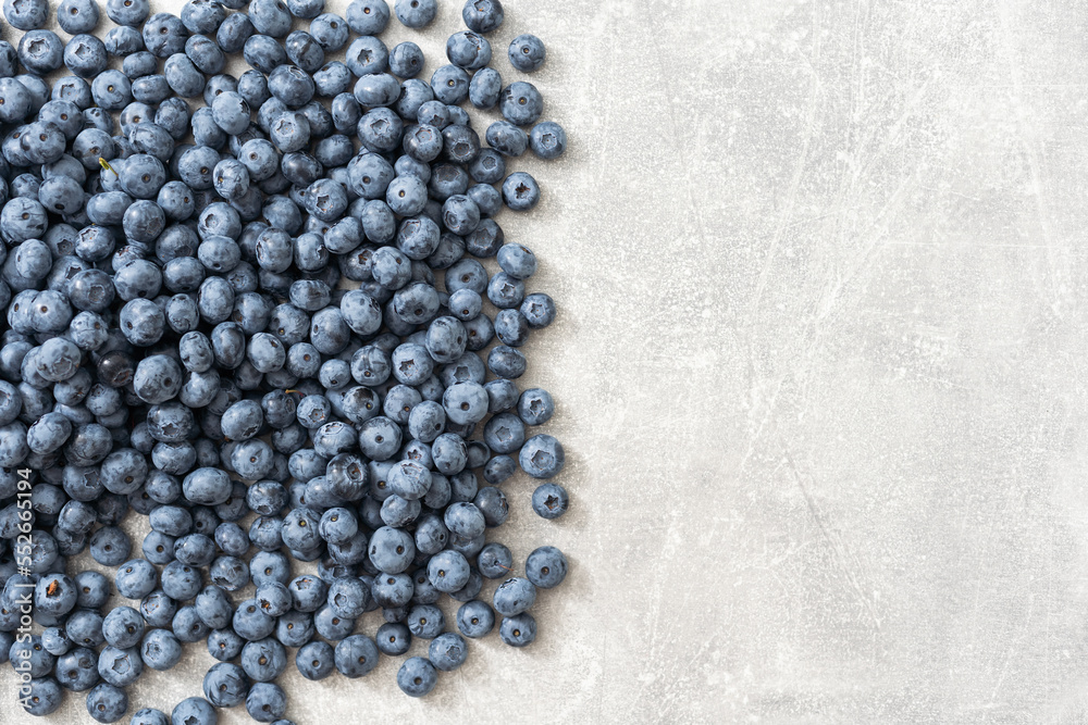 Raw Organic Blueberries on a gray background, side view. Copy space.