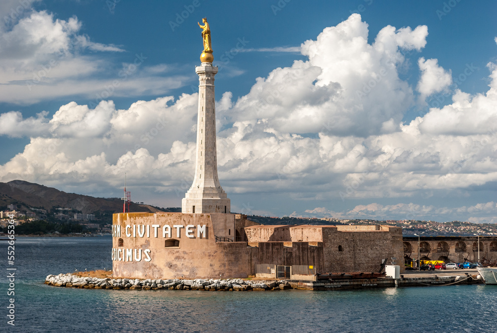 Golden statue of Madonna della Lettera on top of an obelisk at the entrance of the harbor of Messina, in Sicily