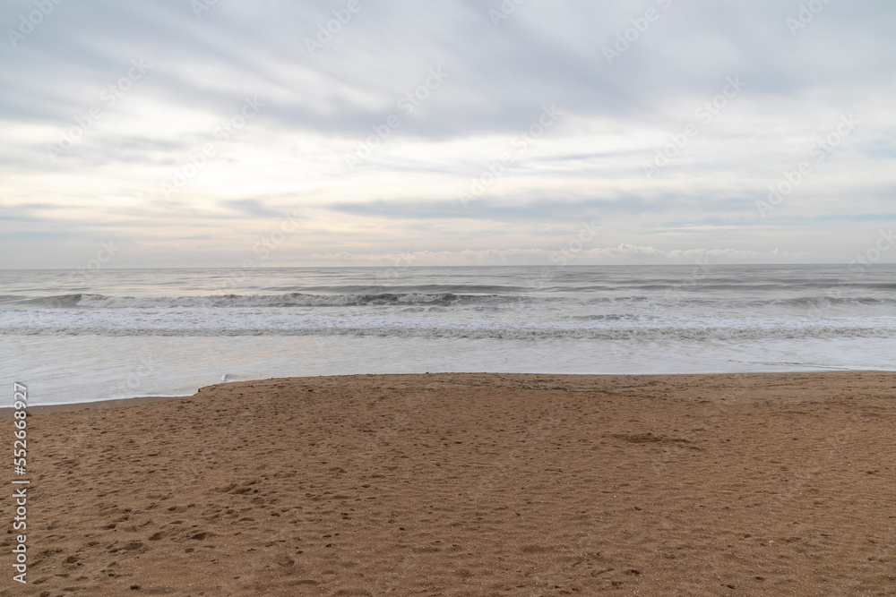 Frontal views of waves from the beach. A cloudy day.