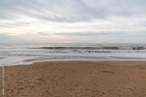 Frontal views of waves from the beach. A cloudy day.