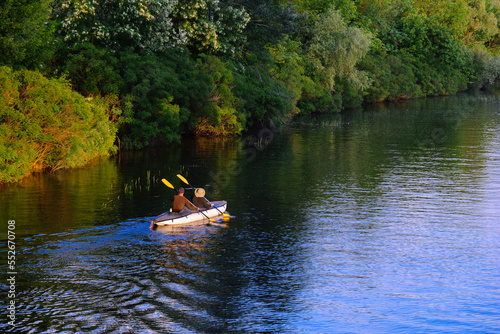 A couple of people are kayaking on the river. © Aleksii Smoliakov