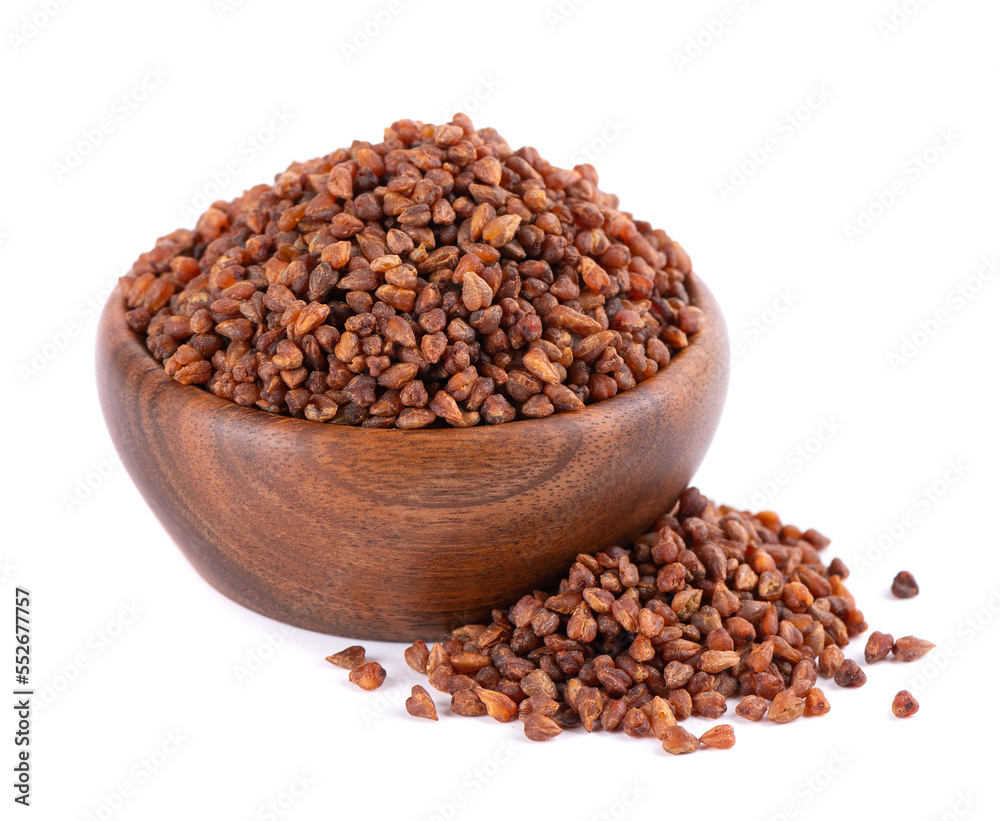 Buckwheat tea in wooden bowl, isolated on white background. Whole roasted buckwheat grains. Fagopyrum tataricum. Buckwheat tea in wooden bowl, isolated on white background. Whole roasted buckwheat grains. Fagopyrum tataricum.