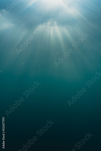 Underwater vision of sun ray light. Turquoise ocean.