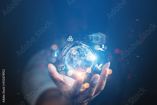 Fototapeta Naklejka Na Ścianę i Meble -  Businessman presenting futuristic business world metaverse graphic. In the form of innovation in digital business processing technology, innovation of the 21st century	