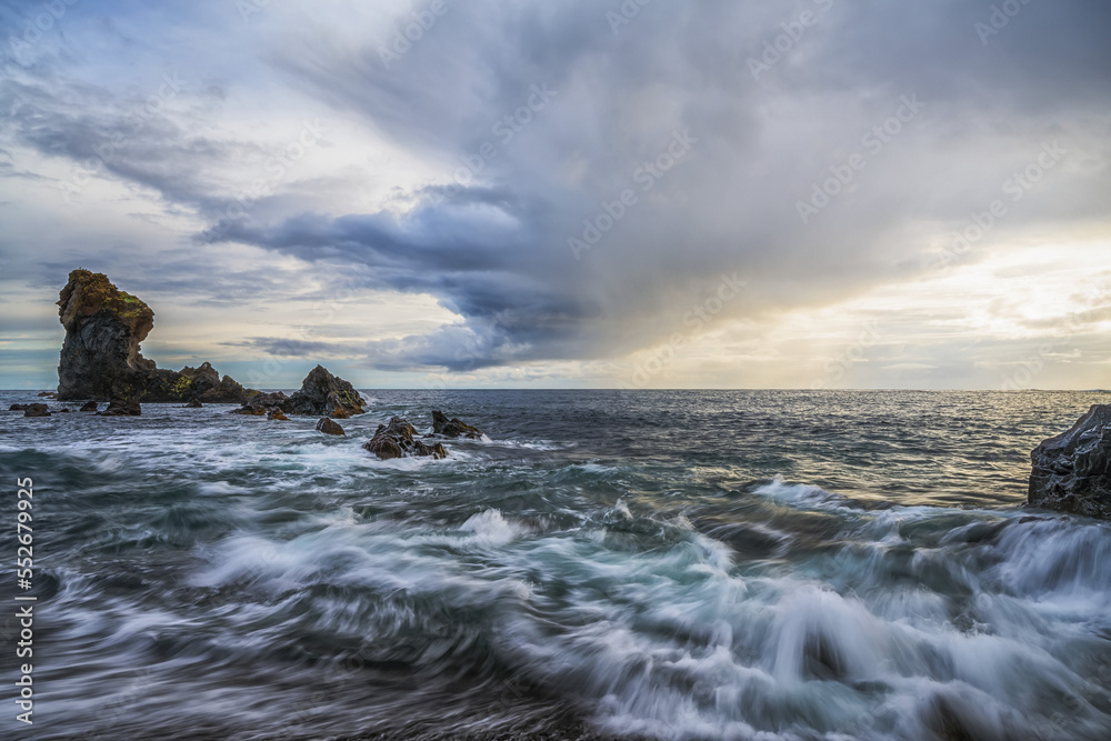 Waves crash against the shoreline of Djupalonssandur beach at sunset, Snaefellsness Peninsula; Iceland Waves crash against the shoreline of Djupalonssandur beach at sunset, Snaefellsness Peninsula; Iceland