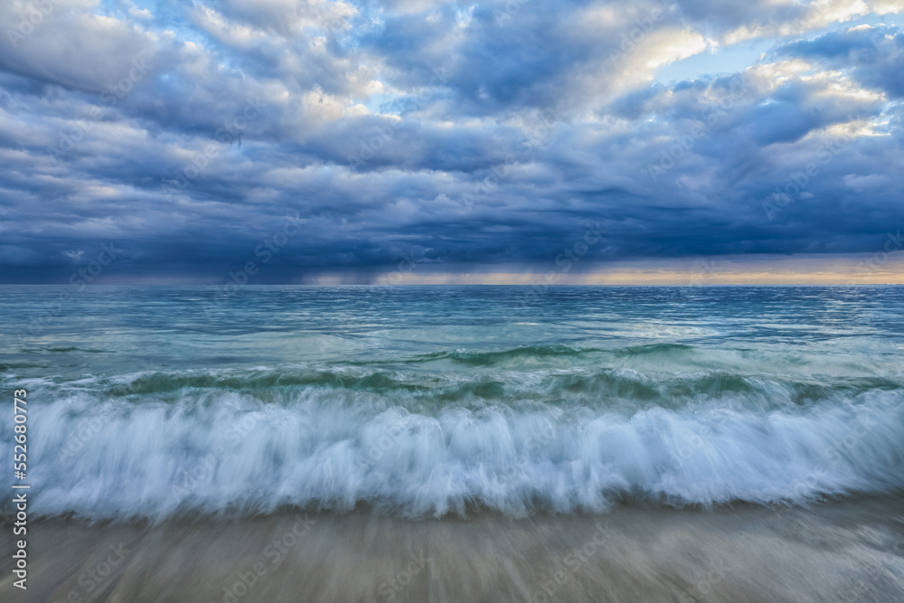 Waves crashing ashore the beach on a moody morning in Oahu, Hawaii; Oahu, Hawaii, United States of America Waves crashing ashore the beach on a moody morning in Oahu, Hawaii; Oahu, Hawaii, United States of America