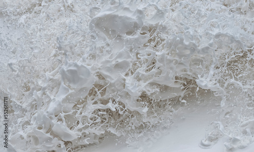 Sea foam explodes in intricate shapes in the ocean along the Oregon Coast; Oregon, United States of America photo