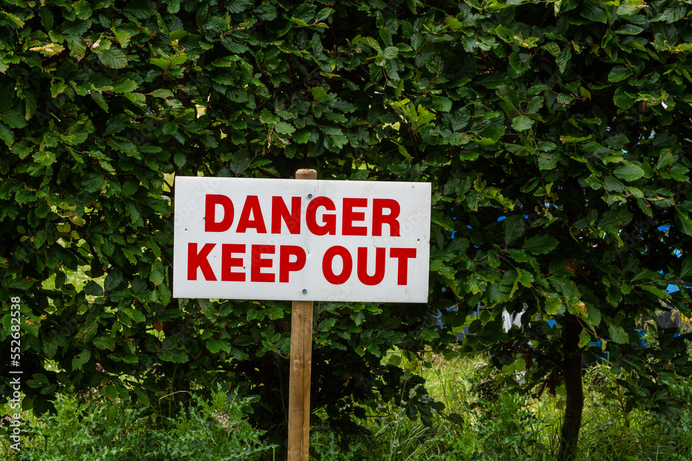 Danger Keep Out sign with trees in the background
