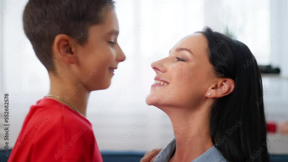 Boy cuddling with his mother, mom and son's close relationship, happy family Boy cuddling with his mother, mom and son's close relationship, happy family