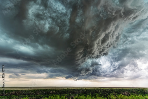 Supercell thunderstorm clouds show off the power of mother nature. Massive clouds build and unleash powerful storms creating a beautiful and awe inspiring spectacle; Colorado, United States of America photo